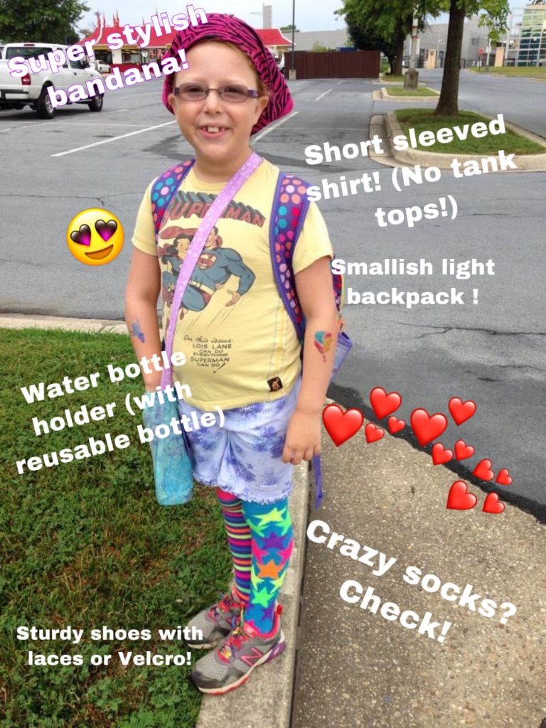 Young camper wearing bandana, short sleeved shirt, backpack, water bottle, shorts, and bright socks.